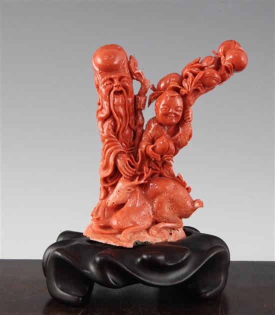 A Chinese red coral group of Shou Lao, an attendant and a deer, 20th century,